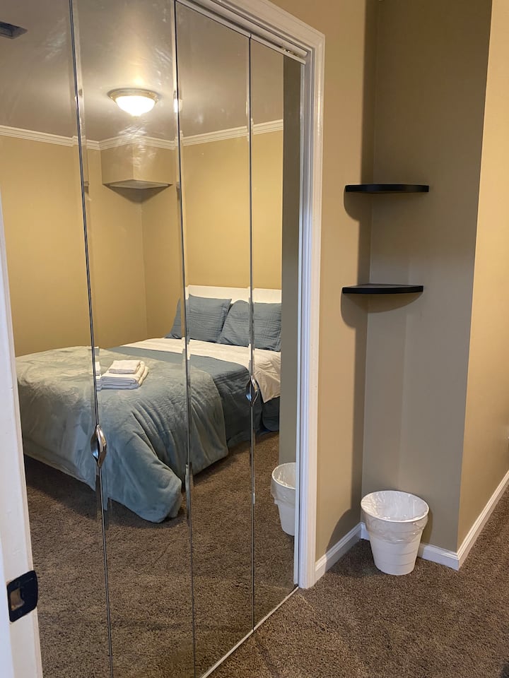 Main Bedroom (Closet View) includes:
* Queen bed
* In room Washer/Dryer Unit
* Iron/Ironing Board
* Noise Machine
* Clothes Hamper
