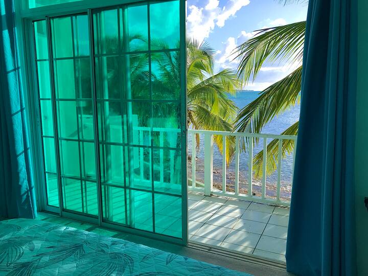 First bedroom with attached balcony overlooking the gorgeous ocean.