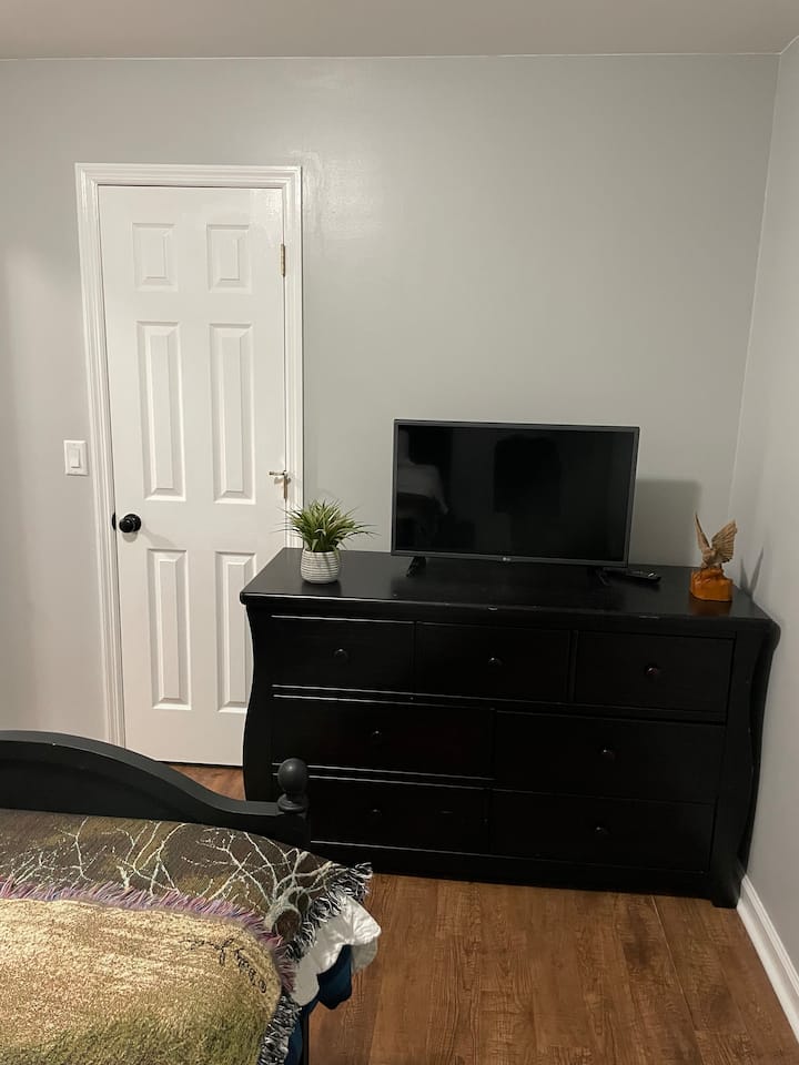 Spálňa s oddelenou posteľou, komodou, televízorom, stolovými hrami a ľahko dostupnými hračkami vo vnútri skrine. 