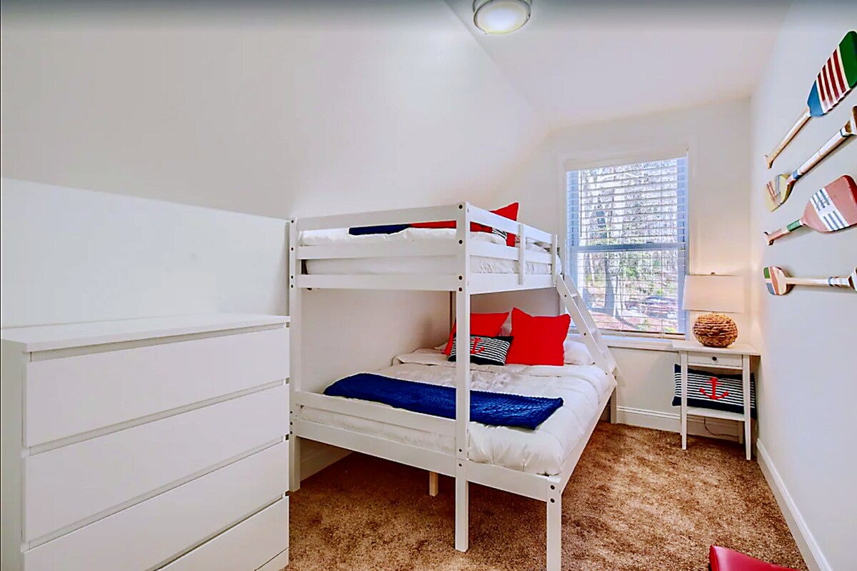 Upstairs bunk room with twin over double bunk bed, dresser, closet.
