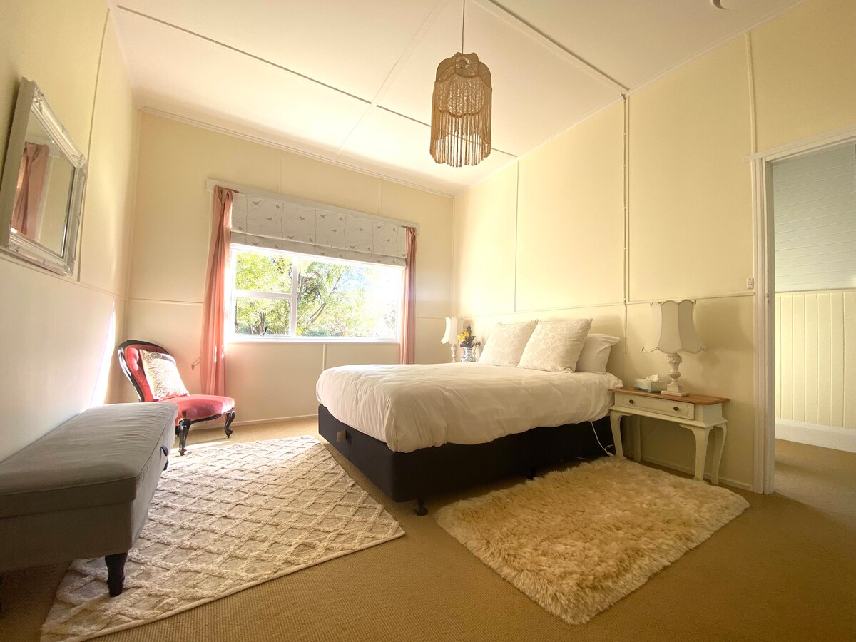 Bedroom one, queen bed, overlooks front garden.