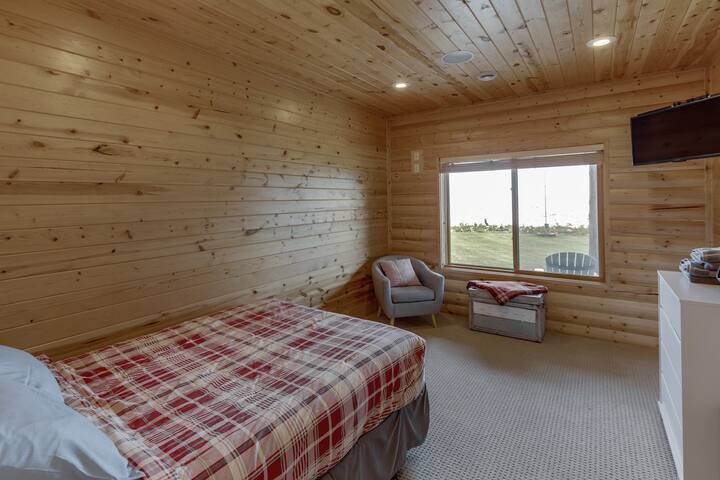 Bedroom two boasts a cozy queen bed and a smart TV for your comfort and entertainment.