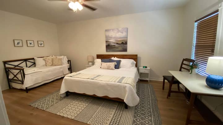 Primary Bedroom with King bed, Twin daybed with a trundle and a workspace