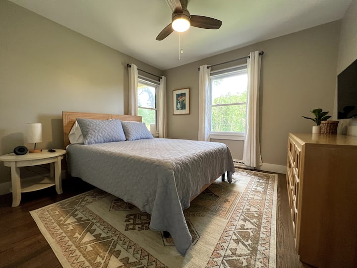 Queen bedroom with 40 in  Smart TV. Bedside tables have lamps with USB ports to charge your electronics as well as a sound machine.