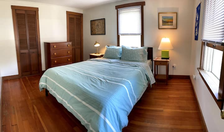 The main bedroom has a comfy queen with memory cooling gel mattress, two closets, a dresser and hardwood floors.