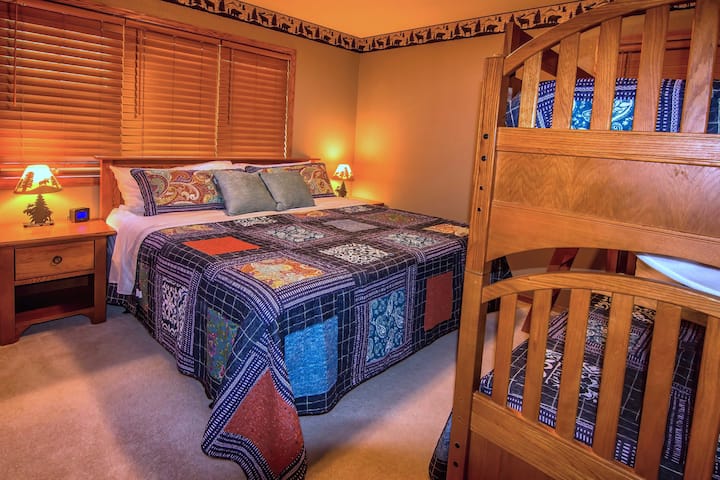 Main floor bedroom with king bed and twin bunk.