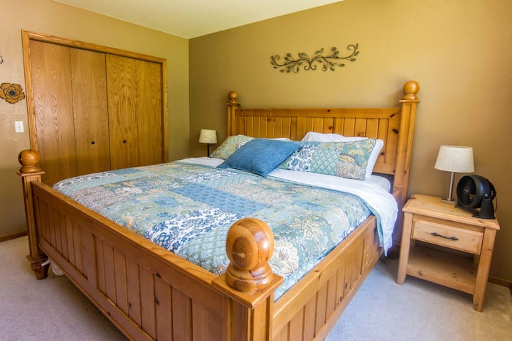 Main floor bedroom. King bed and 55" TV with Direct TV and Disney+.