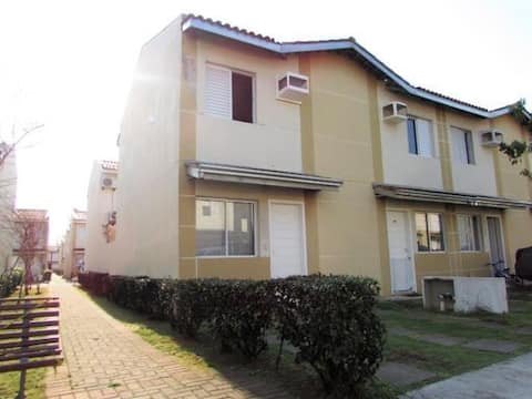 A house in a gated community with a space for a car