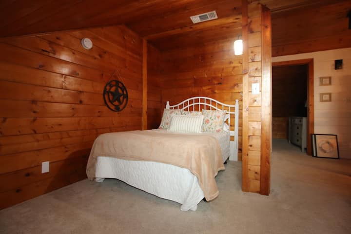 Upper westside bedroom with dormer window and full bed.