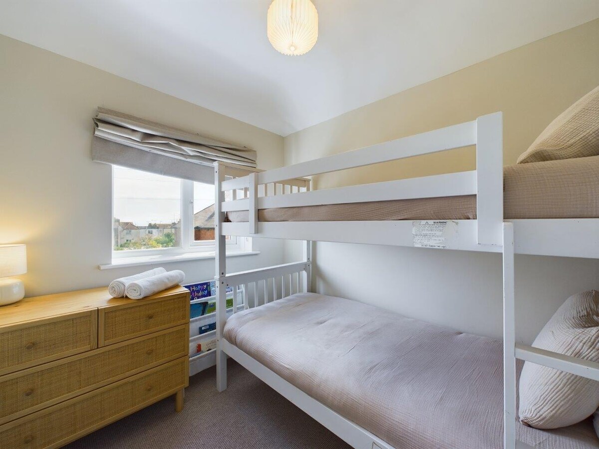 Front bedroom with sea views, bunk beds and chest of draws 