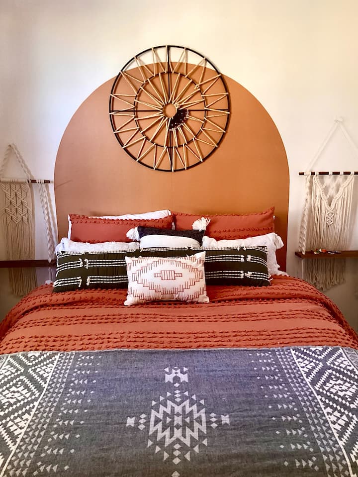 Fun and funky light filled front bedroom with views of the desert. Queen bed, macrame side tables, dresser and large walk-in closet.  Dedicated A/C in room.