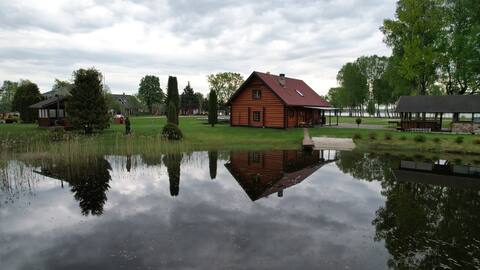Log house with pond and barbecue house