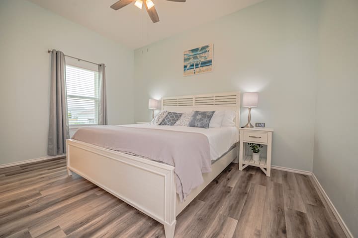 Master bedroom with comfortable king bed.
