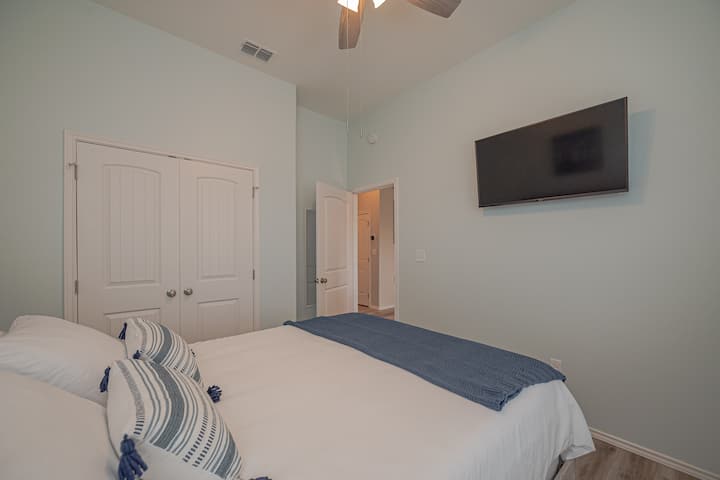 Guest room with queen bed and 43" Smart TV with free movies and entertainment, SmartCast, and streaming services.