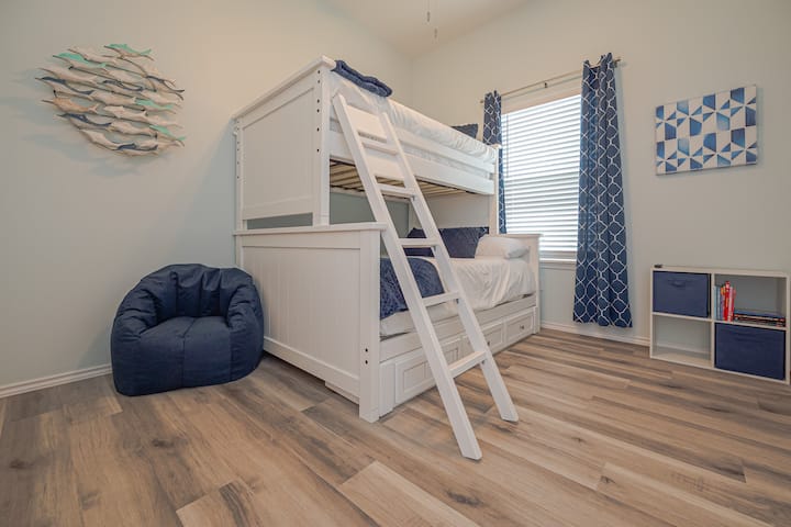 Bunk Beds (twin over full). Children's books and a 43" Smart TV with free movies and entertainment, SmartCast, and streaming services.