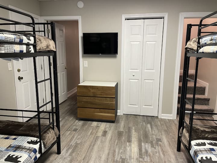Even the bunk room has a Smart TV & dresser. Find extra storage in the closet. The stairs lead up to the kitchen/dining space. The GAME ROOM is right next to the bunk room. Smoke alarms are in every room for your safety. CO alarms on every floor. 
