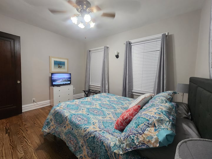 Bedroom one large closet with luggage stand, small dresser, 2 night stands and 32" Smart TV