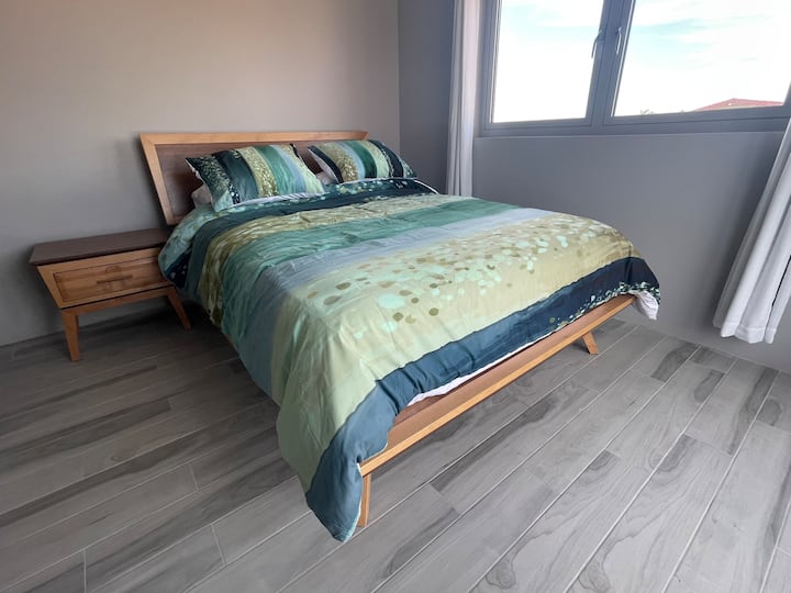 Bedroom 6 -Danish queen bed set with views of the ocean and beautiful palm trees.