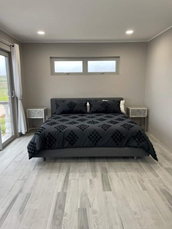 3rd master with Crate and Barrel king bed set, walk in closet and extra large bathroom with views of the ocean from private balcony.