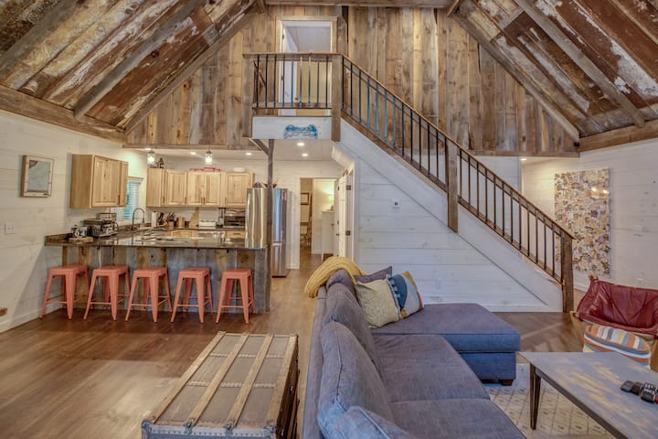 The interior of a New Hampshire cabin is airy and bright with exposed wood