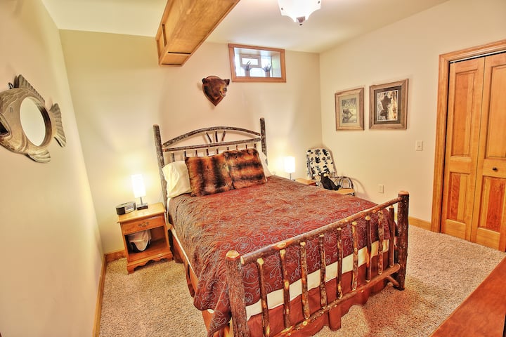 "The Bear Room" one of two bedrooms located on the lower level includes one Queen size bed with both nightstands that have USB charging access, along with a 52" HDTV, Roku with Hard Drive Movie access with over 300+ movies, and DVD player.