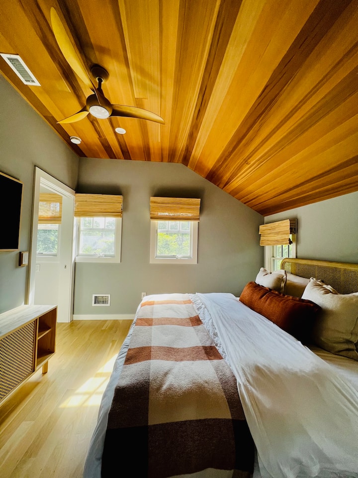 Glavna kuća. Gornji kat, veliki bračni krevet. Probudite se uz pjev ptica, sunčevu svjetlost i mir na selu! (Ako ne želite osvjetljenje, na raspolaganju su vam sjenila za zamračivanje!) Kupaonica s tušem spojena sa sobom. Stropni ventilator. Klima-uređaj/grijanje. Smart TV. Madrac Casper. Ormar. Ogledalo pune dužine. Zvučnik Sonos.