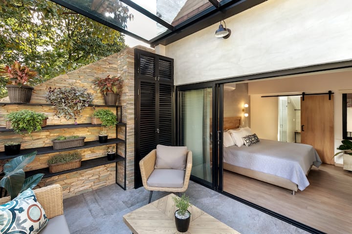 A beautiful 2nd private patio off the master bedroom is surrounded by tropical plants and skyline views.