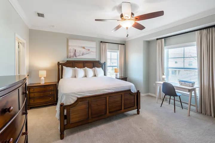 The main bedroom features a king bed with a new Serta Platinum Suite III Euro Top Mattress that provides luxurious comfort, along with a desk and printer.