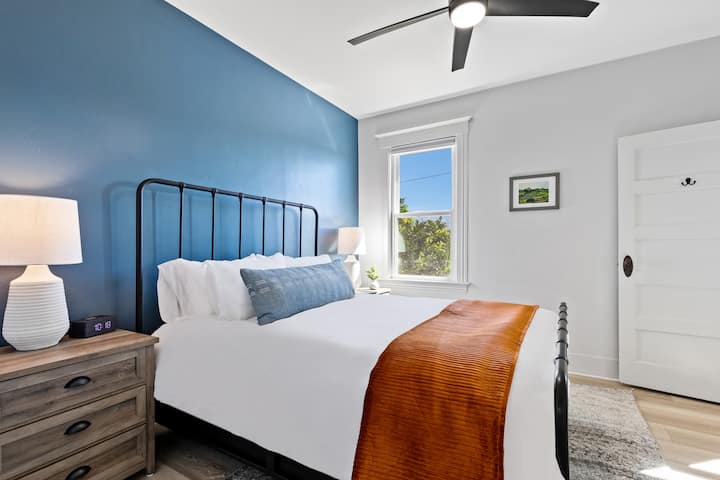 Bedroom 1 of 3 - Queen bed w/ en-suite bath featuring original clawfoot tub/shower combo. All bedrooms have blackout curtains, an alarm clock w/charging cables, folding luggage rack & closet.