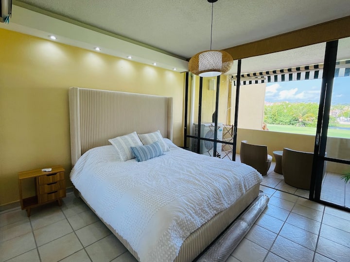 Master bedroom with king size bed, full closet and tranquil view of the 6th hole.  Air conditioned with direct access to private balcony.