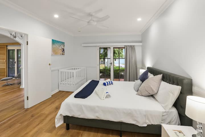 Bedroom 2 with king bed and baby’s cot