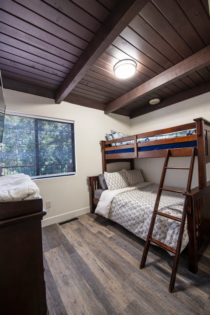 The 2nd bedroom on the main level in the Big house has a full bottom bunk and single size top bunk along with a dresser/changing table for little ones.