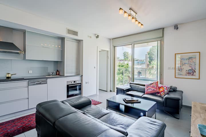 Open-plan living room with kitchen and balcony