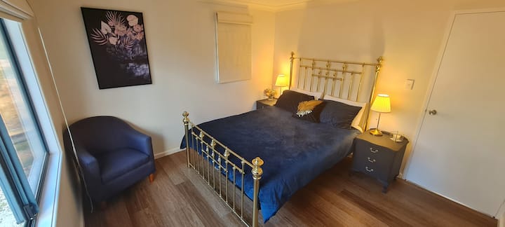 The Royal Suite - styled by our daughter the main guest room is classy with antique brass bed and lamps, upcycled Queen Anne drawers and a lovely sitting area overlooking the property.