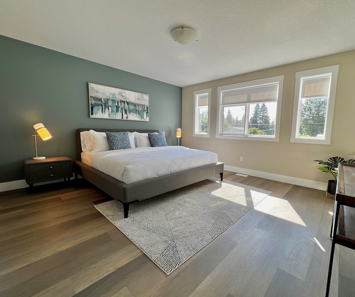The main bedroom provides a king-size Bloom brand mattress, premium bedding,  walk-in closet, and a 55" smart TV 