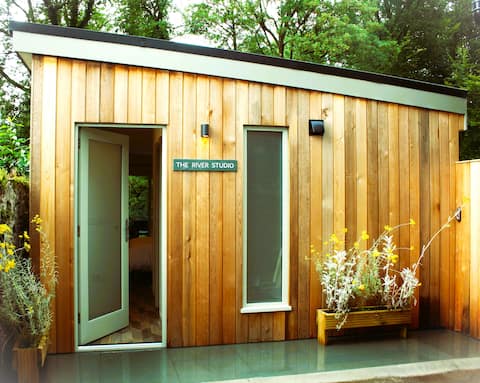 relaxing studio space overlooking water and woods