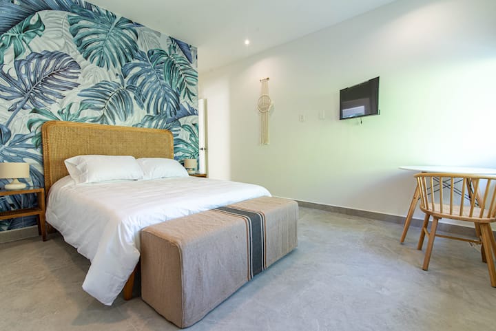 1st guest bedroom with 32" inch HDTV, closet, and desk.