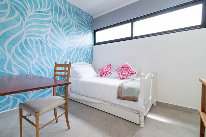 1st level small office/den with a single bed and trundle.