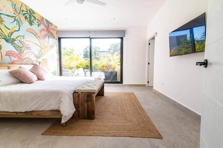 Master bedroom with private balcony and HDTV 43".