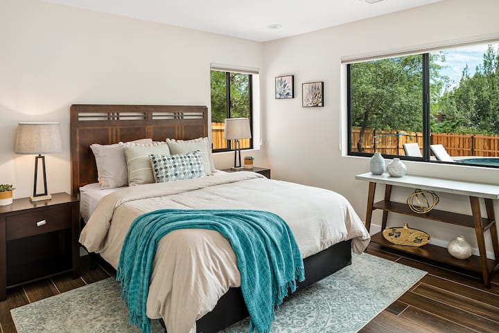 4th bedroom with a queen bed and views to the backyard.
