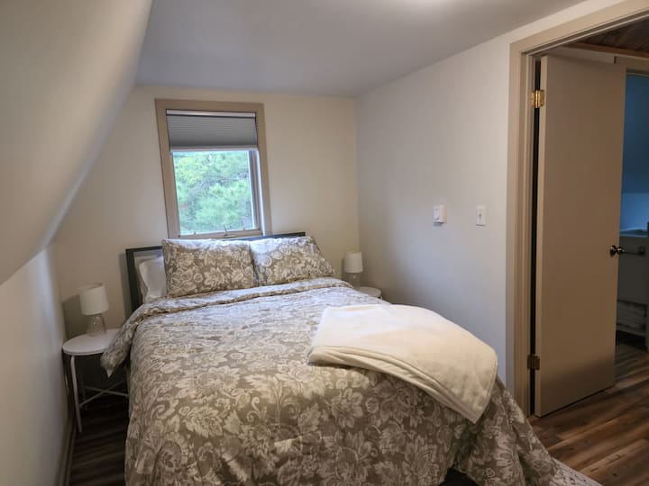 Comfy loft bedroom has a walk in closet and full size bed.