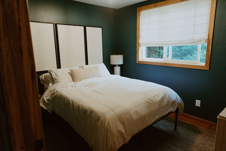 The main bedroom sits on the ground floor and features a queen size bed with Molecule mattress and topper.