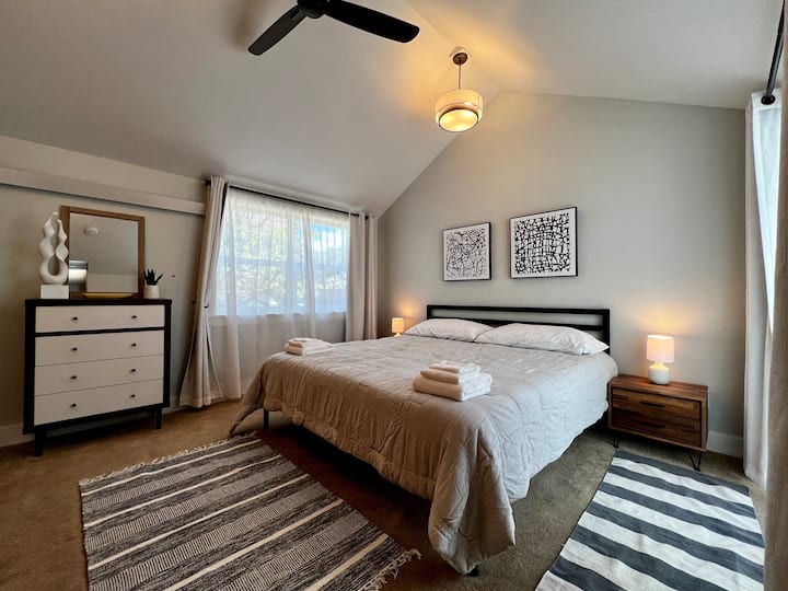 This main bedroom boasts two large closets, two massive windows and vaulted ceilings. It overlooks the back yard garden and is a quiet nook. 