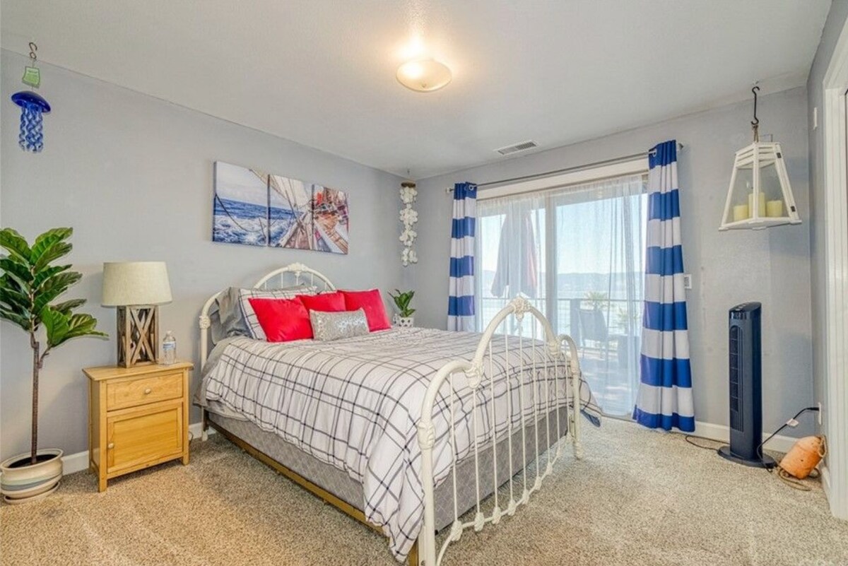 Спална соба на горниот кат со брачен кревет (широк 150-179 см) и лизгачка стаклена врата со пристап до балконот.