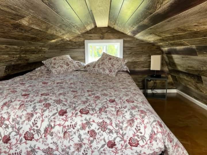 Queen bed with reading light and charging ports (ladder access required)