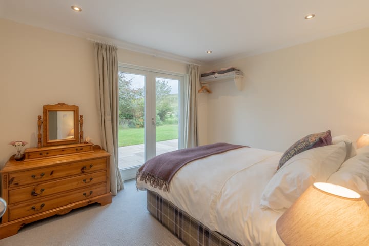 French doors lead to a small patio in our ensuite bedroom  which has a comfortable king size bed. Our beds and mattresses are handmade in the Highlands by a long established social enterprise company.  Our duvets are 'eco comforel' made in Scotland.
