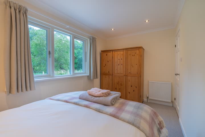 The third bedroom with a double bed and plenty of cupboard space.