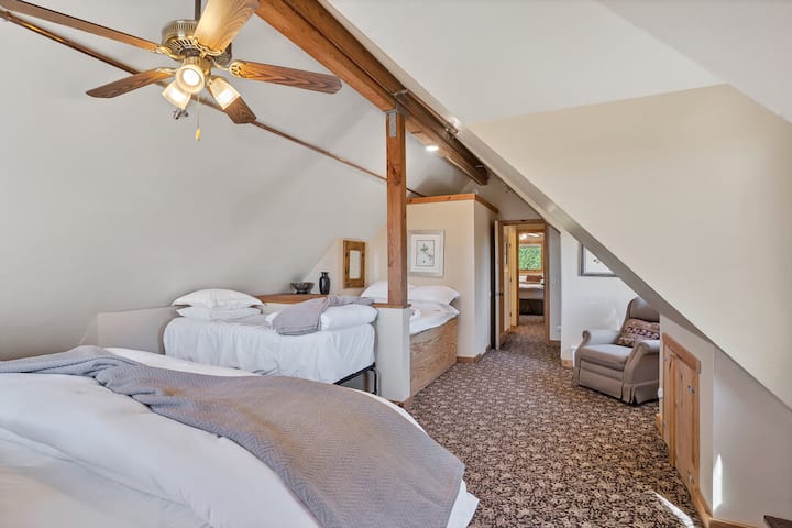 The larger of the two 2nd floor bedrooms contains a king, a small twin, and a full, and comfortably sleeps 4.
