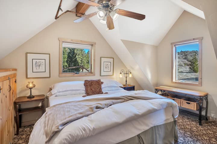 The smaller of the two 2nd floor bedrooms has a king bed and views up the hill out back, where we often see deer and turkeys on fall and spring mornings.