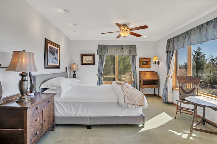 The master bedroom features a California king bed and some of the best views in the house.